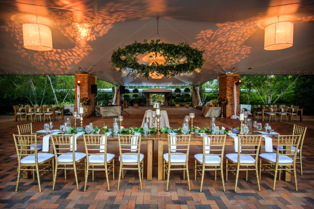 Wedding flowers hanging from ceiling at reception at the mcginley pavilion at the chicago botanic garden-123