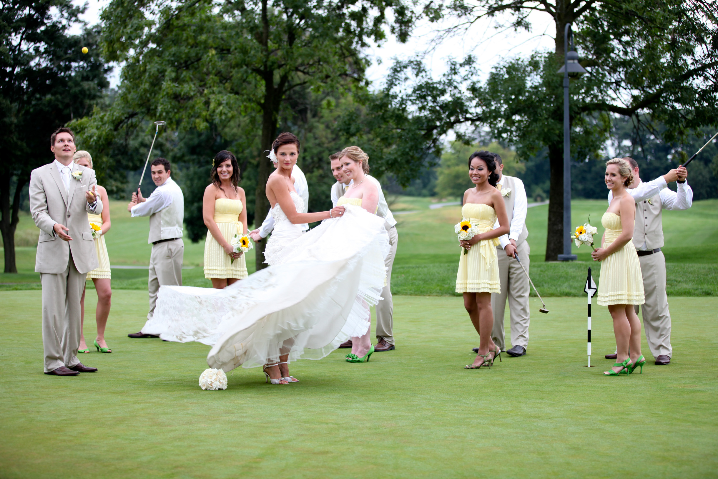 Wedding party ongolf course goofing around and acting funny