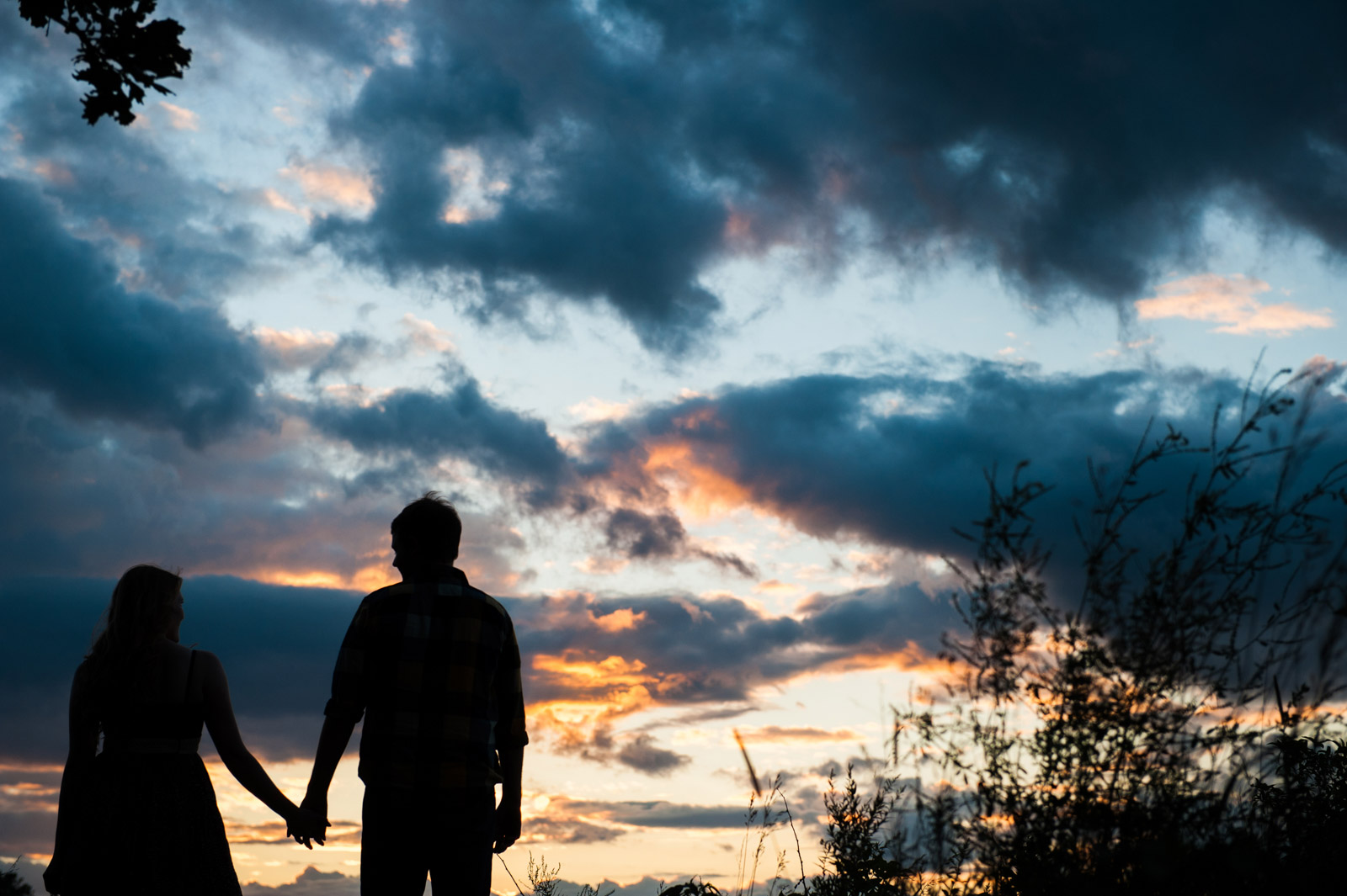 Engagement Session couple holding hands in silhouette at sunset