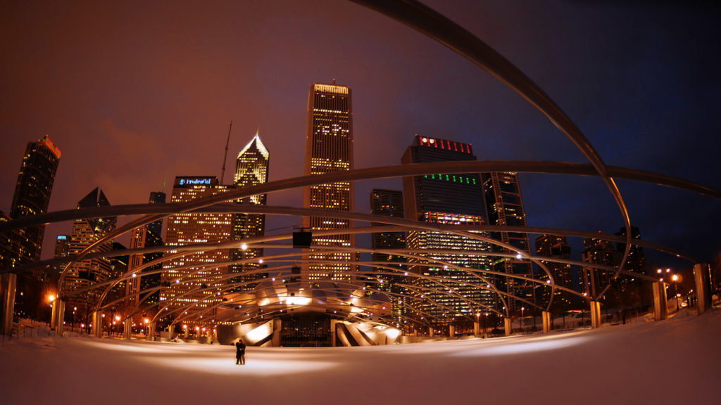 Engagement session couple in Millennium Park standing in snow in winter