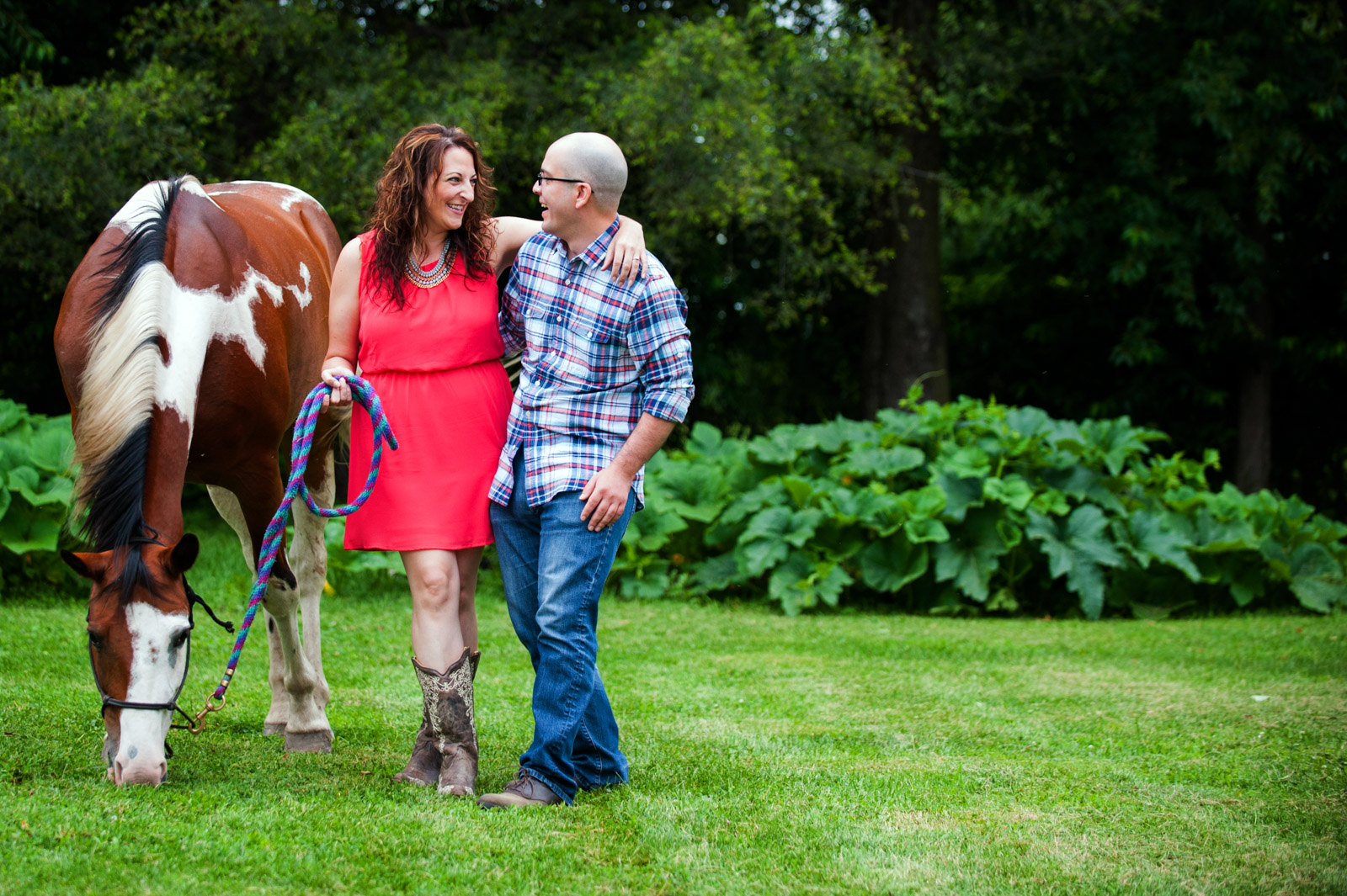 Farm engagement session photo with engaged couple and horse