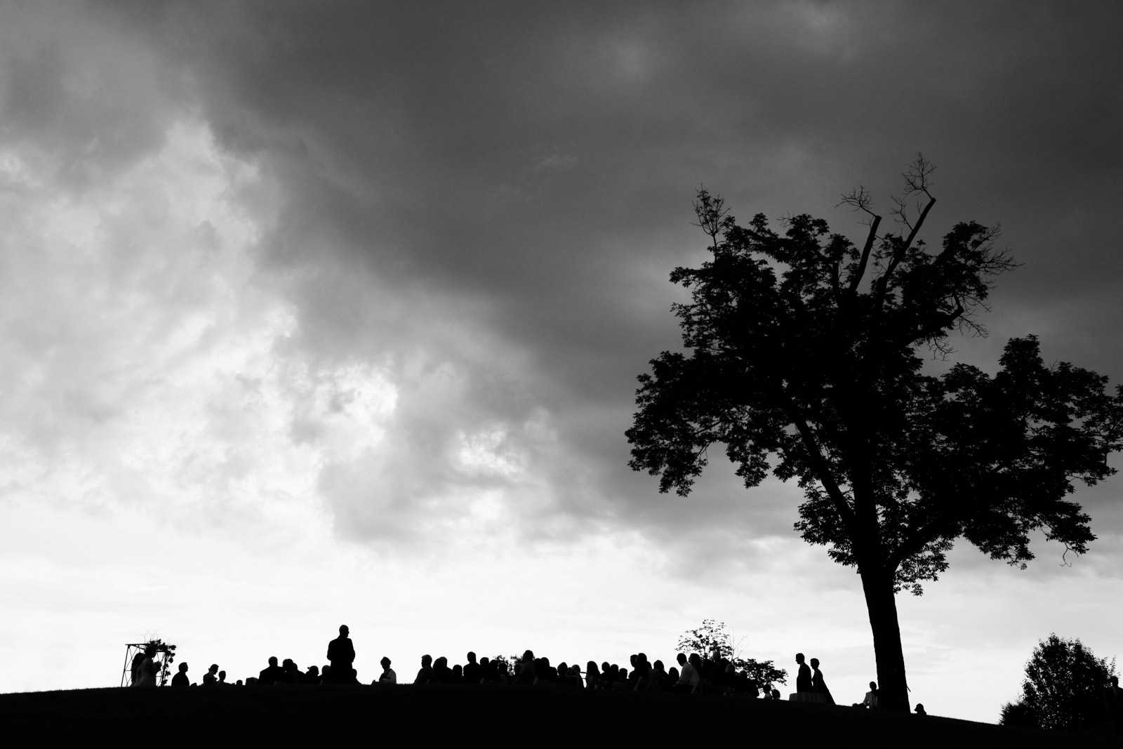 Bride and her father walking down the aisle of her ceremony before rain storm