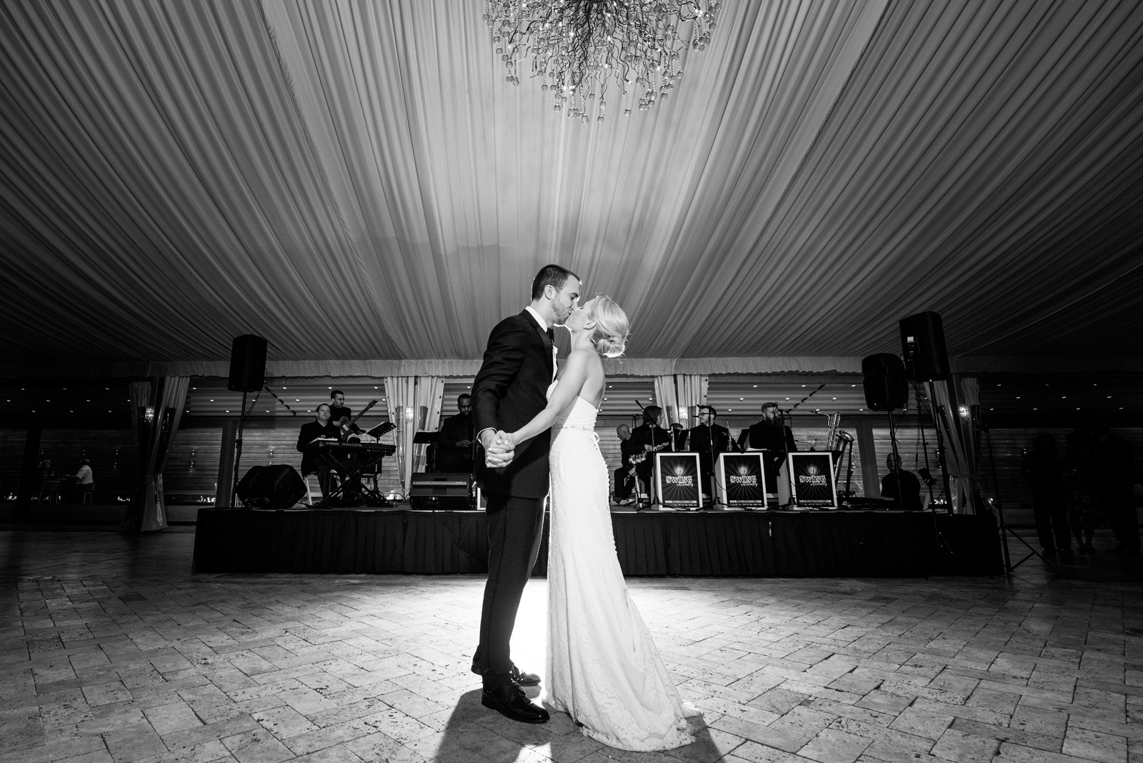 Stunning black and white photo of bride and groom kissing during First Dance