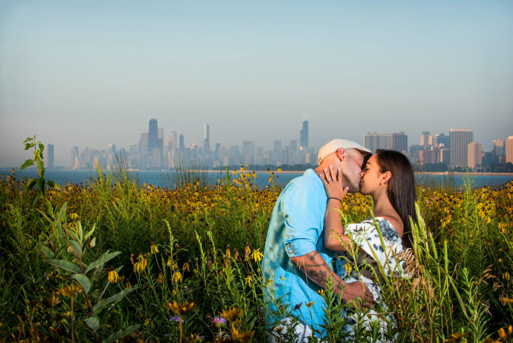 Couple kissing in field of sunflowers at the Magic Hedge in Chicago Montrose Avenue Beach