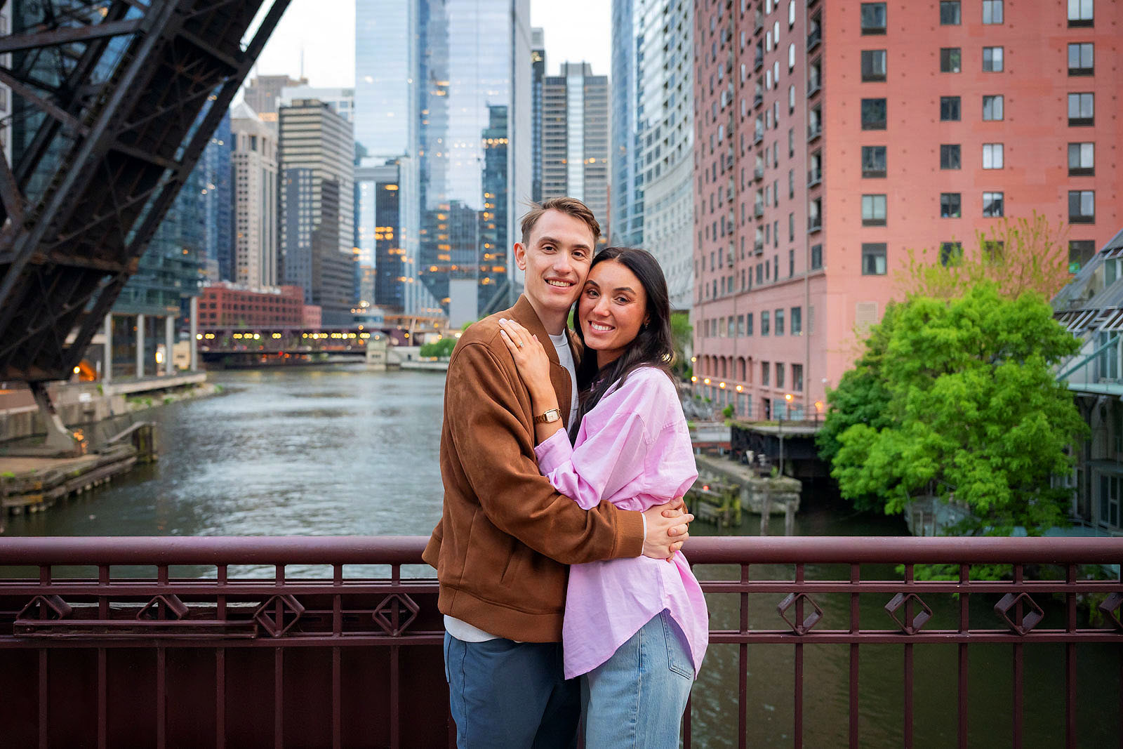 Proposal couple standing on Kinzie Street Bridge posing for Engagement Photos in Chicago