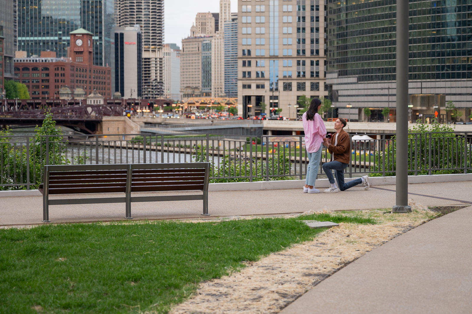 Man proposing on one knee to his girlfriend at River Point Park along the Chicago Riverwalk